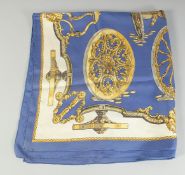 A HERMES SILK SCARF. Blue with wheels. 2ft 9ins x 3ft in a Hermes box.