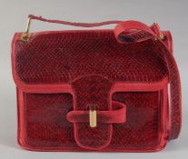 A VINTAGE PIERRE CARDIN OF PARIS RED SNAKESKIN BAG. 10ins long, 8.5ins deep with long handle, in a