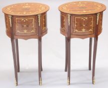 A PAIR OF OVAL INLAID BEDSIDE TABLES with three drawers on curving legs. 2ft 4ins high, 1ft 4ins