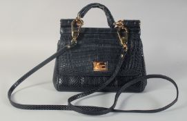 A GOOD DOLCE AND GABBANA BLACK CROCODILE OR SNAKESKIN BAG. 9ins long, 7ins high, in a dust bag.