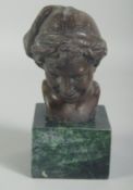 A SMALL BRONZE BUST OF A BOY on a square marble base. 3ins high