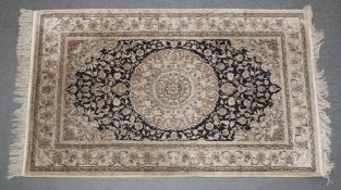 A GOOD PERSIAN PART SILK RUG with stylised floral decoration on a cream, blue ground. 155cm x 93cm.