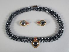 A FOUR ROW HEMATITE BEAD NECKLACE with a 9ct GOLD PENDANT AND MATCHING PAIR OF EARRINGS in