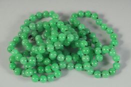 A VERY GOOD STRING OF BEADS with white gold and diamond clasp. 52ins long.