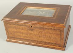 A 19TH CENTURY WOODEN JEWELLERY BOX the lid with a print of a country house. 9.5ins.