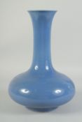A CHINESE PORCELAIN BLUE BULBOUS VASE. 13ins high.