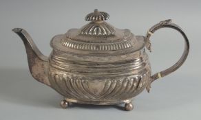 A GEORGE III SILVER TEA POT on four ball feet. London 1814, weight, 19ozs.