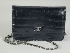 A SMALL CHANEL BLACK LEATHER BAG 18cm long, 12cm wide with long chrome and leather straps, 60cm