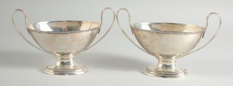 A GOOD PAIR OF GEORGE III SILVER OVAL TWO HANDLED SAUCE TUREENS with bead edge. London 1784.