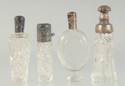 FOUR SILVER TOP SCENT BOTTLES.