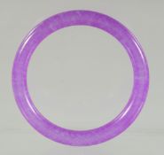 A LAVENDER JADE BANGLE. 7.5ins diameter.