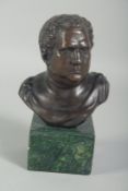 A SMALL BRONZE BUST OF A ROMAN on a square marble base. 3ins high.