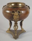 A REGENCY ONYX BOWL with bronze rams heads on a tripod base. 6ins high.