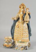 A FRENCH POTTERY FIGURE GROUP, QUEEN HOLDING A DOLL, possibly French. 11.5ins high.