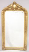 A LARGE GILTWOOD MIRROR. 5ft 2ins high, 2ft 9ins wide.