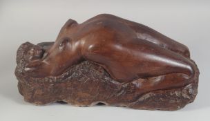 A VERY GOOD CARVED RED STONE NUDE RECLINING FIGURE. 18ins long.