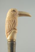 A CARVED BONE HANDLED WALKING STICK 