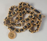 A LONG CHANEL LEATHER THREADED THROUGH THE CHAIN BELT, CHANEL MEDALLION. 3ft 6ins.