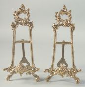 A SMALL PAIR OF BRASS EASELS 9ins high.