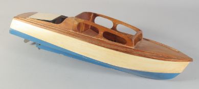 A MOTORISED WOODEN CRUISER, circa 1950. 25ins long.