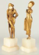 DORVAL (CIRCA. 1930) A GOOD PAIR OF GILT BRONZE FIGURES of a young lady and a man with ivory