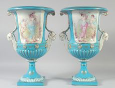A LARGE PAIR OF CONTINENTAL LIGHT BLUE TWO HANDLED URN SHAPED VASES with heads as handles. 17ins