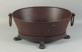 AN IRON CIRCULAR PLANTER with ring handles on claw feet. 1ft 8ins long.