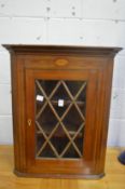 An inlaid mahogany hanging corner display cabinet.