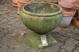 A small pedestal composite garden planter.