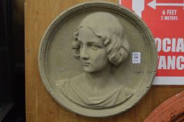 A moulded composite wall plaque modelled with a bust of a young lady.