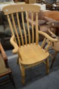 A Victorian style beech high back Windsor armchair.