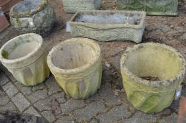 A set of three composite garden planters.