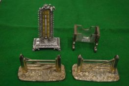 A silver desk thermometer, silver mounted glass match striker and a pair of novelty five bar gate