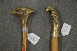Two walking sticks, the brass handles modelled as birds.