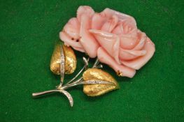 A gold, silver, diamond and carved coral floral brooch.