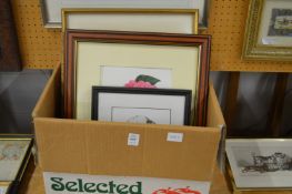 A box of assorted paintings and prints.