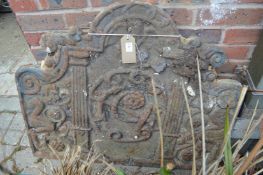 A large cast iron fireback.