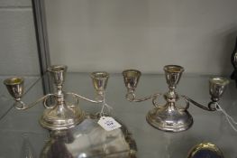 A pair of silver twin branch three light candelabra.
