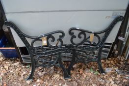 A pair of cast iron bench ends.