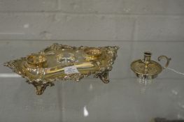 A silver desk stand or inkwell (lacking bottles) together with a miniature chamber stick.