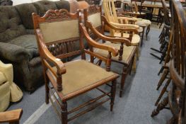 A pair of Victorian walnut framed spindleback open armchairs.