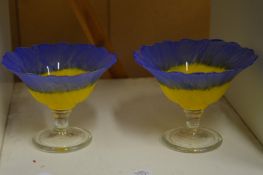A pair of colourful sundae glasses.
