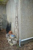 A wrought iron plant spire 243cm high including feet.