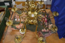 A brass chandelier and a throw.