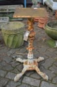 A pair of painted cast iron table stands.