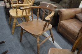 A beech and elm smokers bow armchair.