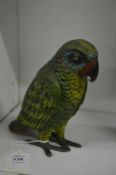 A painted spelter model of a parrot.