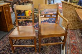 A set of six country made elm solid seat dining chairs, two with arms.