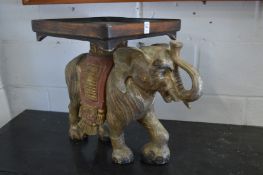 A pair of carved wood gilded and painted elephants stands/tables.