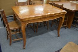 A French fruitwood draw leaf dining table.
